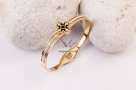 Regal Clover Black Background with Gold Bracelet