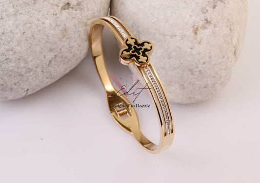 Regal Clover Black Background with Gold Bracelet