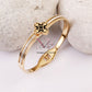 Regal Clover Black Background with Gold Bracelet